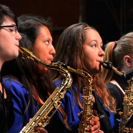 Students playing saxaphone band instrumental festivals