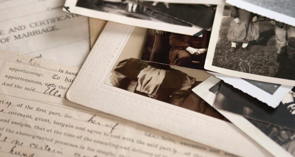 Pile of photographs sitting on top of a handwritten letter