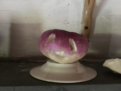 Turnip with face carved into it 